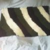 a hand woven classic rug, to use as bathroom or door mat .