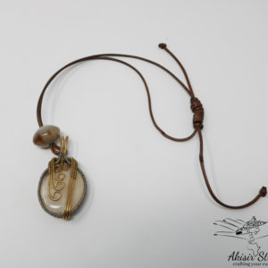 Elegant, delicate glass bead and cow-horn with wire wraps pendant.