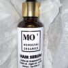 A jar of hair serum.contains oils esssential for hair growth