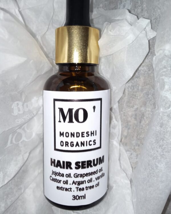 A jar of hair serum.contains oils esssential for hair growth